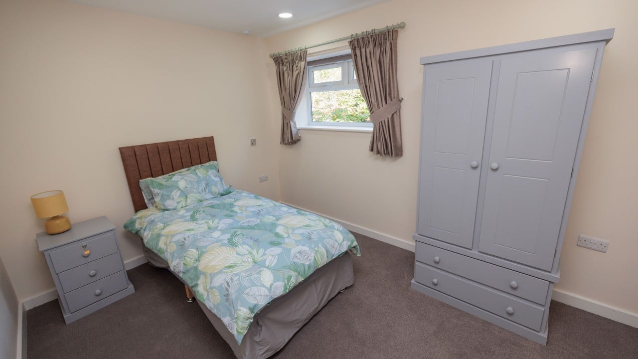 A lovely bedroom for our care home residents with furniture at Riseley House Care Home in Macclesfield