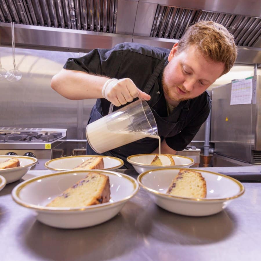 Chef Liam making a tasty Cake and Custard in the kitchen at Riseley House Care Home in Macclesfield - Care Home Dining in Macclesfield