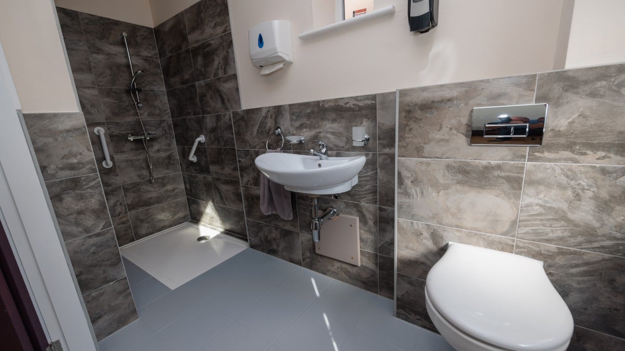 An ensuite bathroom, with walk-in shower and lots of space in one of our care home bedrooms at Riseley House Care Home in Macclesfield