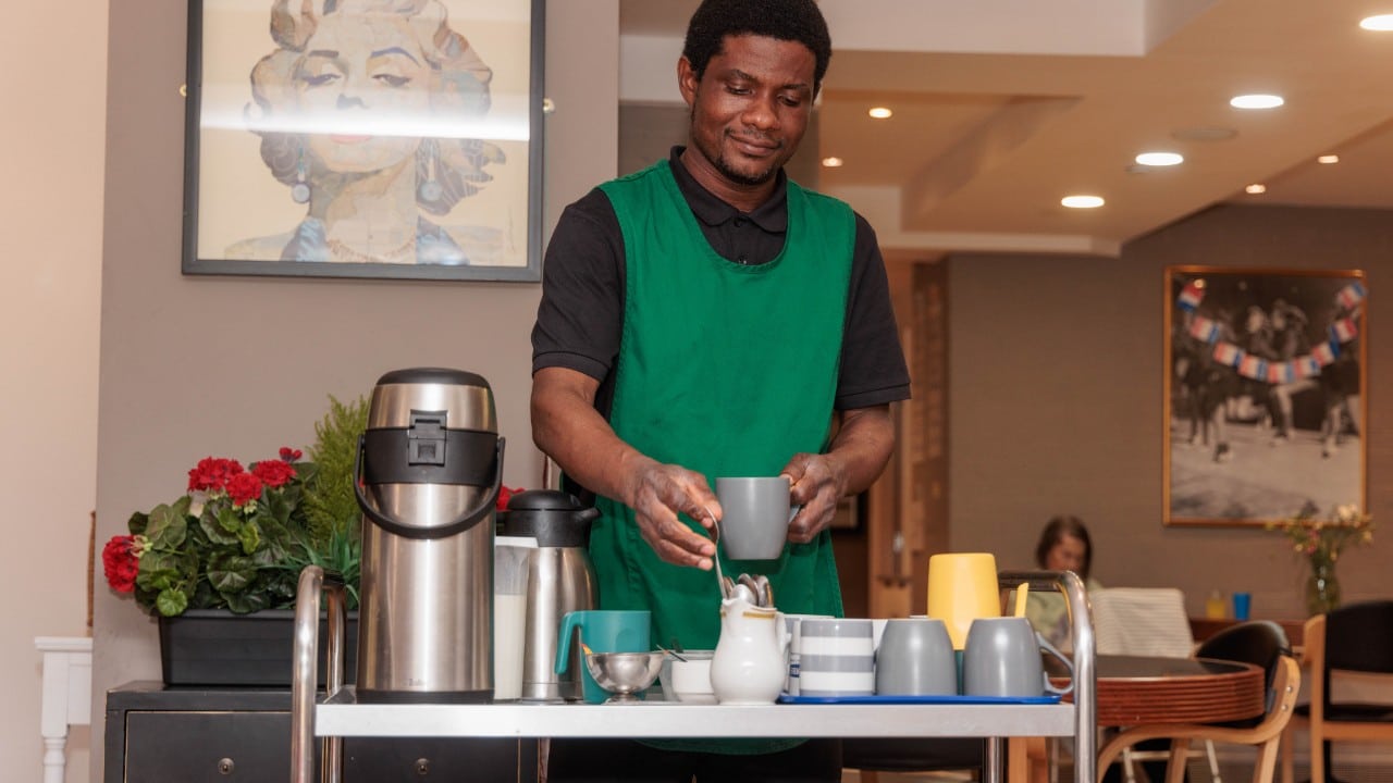 A carer making a brew for a resident at Riseley House Care Home in Macclesfield