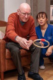 A resident and carer enjoying an activity at Riseley House Care Home in Macclesfield - Health and Well-being Care Macclesfield