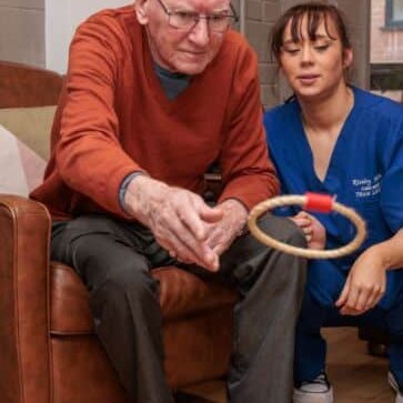 A resident and carer enjoying an activity at Riseley House Care Home in Macclesfield - Health and Well-being Care Macclesfield