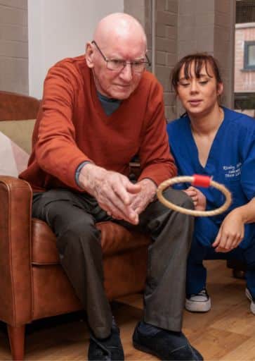 A resident and carer enjoying an activity at Riseley House Care Home in Macclesfield - Health and Well-being Care Macclesfield